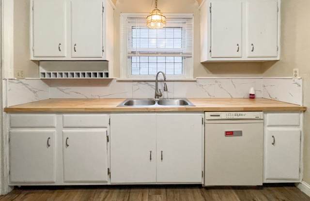 Large, 5 bedroom Home with wood flooring and updated bathroom, close to campus with a fenced yard and fire pit. Gallery 1