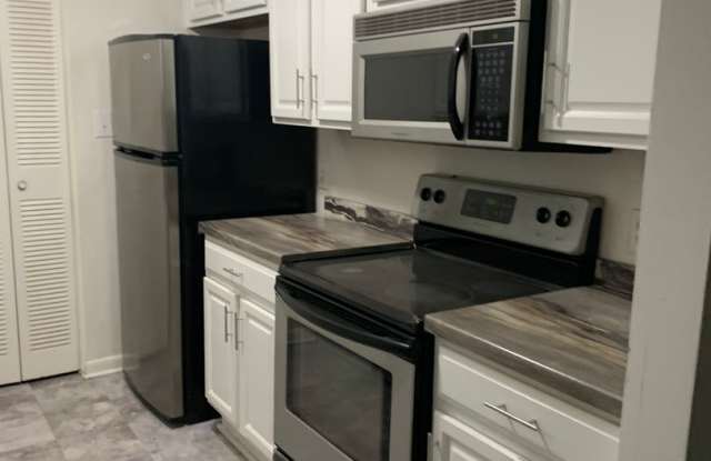 MAY 2025 RENT FREE--LOCATED NEAR CRABTREE-- CONDO AT MARTINIQUE-4507-c Edwards Mill Rd- LARGE LIVING ROOM-POOL ON SITE photos photos