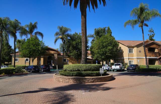 Spacious single-story, ground-level corner unit located in a desirable gated community. Gallery 1