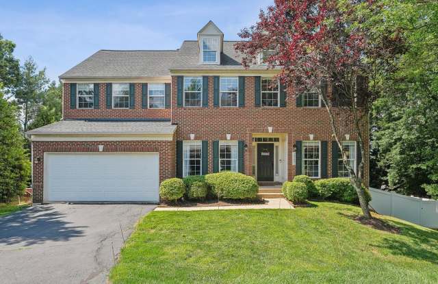 Welcome to this stately brick-front colonial with a spacious two-car garage. photos photos