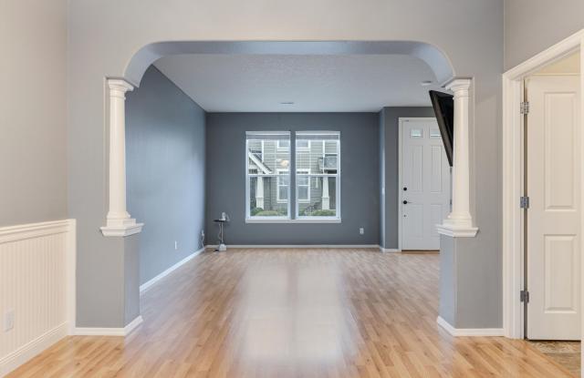 Lovely and bright townhouse with a hard wood flooring throughout, a 2 car garage, AC & more! photos photos