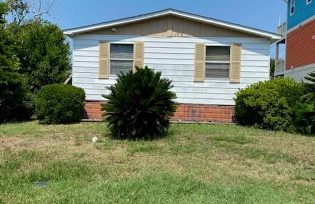 Introducing a charming 3-bedroom, 2-bathroom house located in the desirable Carolina Beach, NC. photos photos