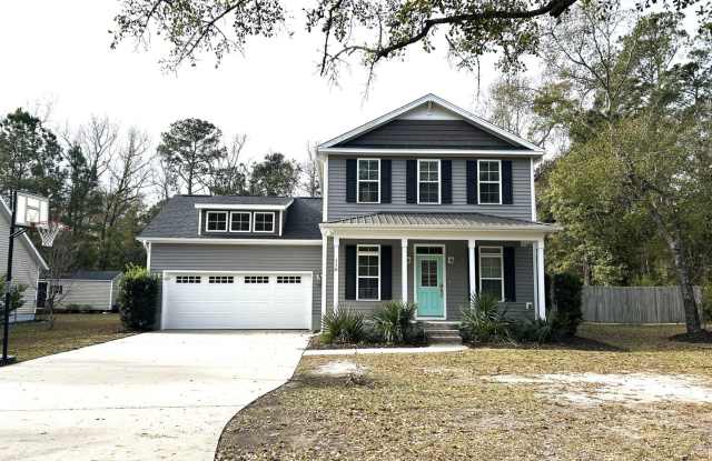Enjoy private living in this beautiful 3 bedroom, 2.5 bathroom home on almost half acre lot! - 110 Futch Creek Road, Porters Neck, NC 28411
