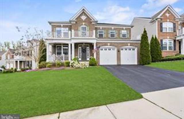 This beautifully maintained single-family home offers five bedrooms, four-and-a-half bathrooms, a spacious open-concept floor plan, and modern finishes throughout. photos photos