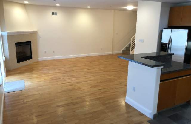 OPEN TOMORROW! Huge bi-level 3 bedroom 2.5 bath loft style apartment w/huge sunny yard, gas fireplace, remodeled kitchen, in-unit laundry and garage parking Gallery 4