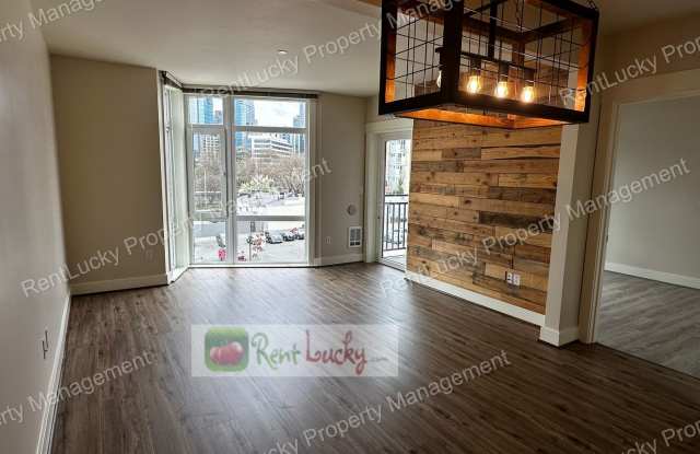 GREAT NEW PRICE! Gorgeous 1 Bedroom + 2 Baths + Den w/Secured Parking Spot in Prime Seattle Location! Gallery 1