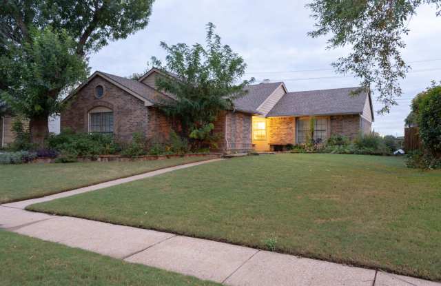 Tile throughout entry, living area, and dining. The House features a wood burning fireplace, perfect for cozy weather! - 1308 Crestwood Court, Allen, TX 75002