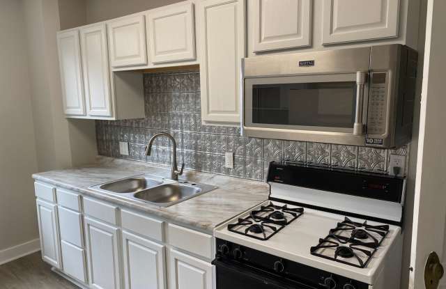 2 Bedroom + Den, Updated Row House with Off-Street Parking! photos photos