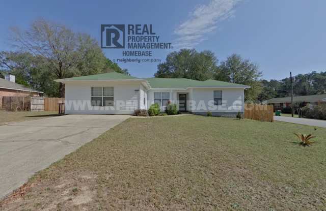MOVE-IN BONUS: Free 58-inch TV with approved 12-month lease! SPACIOUS 5-BED, 3-BATH GEM | Private Fenced Yard + W/D Included! - 711 Ridge Lake Road, Okaloosa County, FL 32536