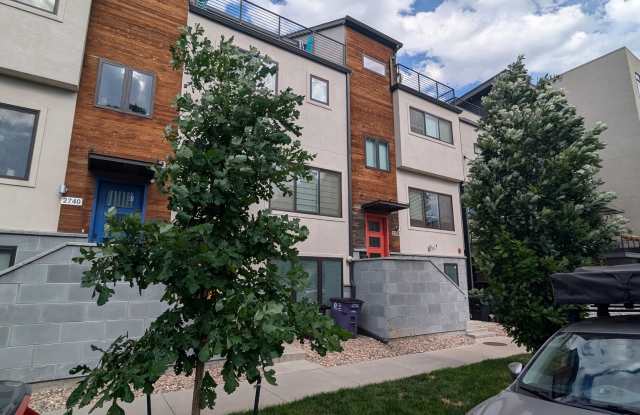 STUNNING 4-LEVEL TOWNHOME IN HIGHLANDS W/ 2-CAR GARAGE +AMAZING ROOFTOP DECK WITH VIEWS! Gallery 1