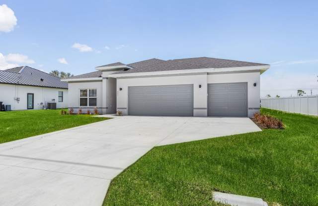 Model home available to view; 7 months old NEW construction , 3-CAR GARAGE 4 bed 2 baths home, Fenced In Backyard - 703 Northeast Juanita Court, Cape Coral, FL 33909 Model home available to view; 7 months old NEW construction , 3-CAR GARAGE 4 bed 2 baths home, Fenced In Backyard - 703 Northeast Juanita Court, Cape Coral, FL 33909