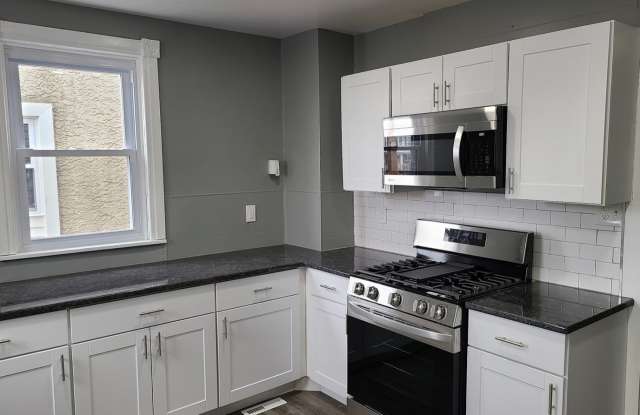 Twin home with updated kitchen, washer/dry on first floor, private back yard and porch. Gallery 4