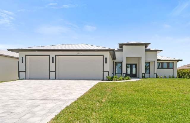 Brand new 4 plus den 3 car garage direct access pool home! - 1523 Northwest 34th Avenue, Cape Coral, FL 33993