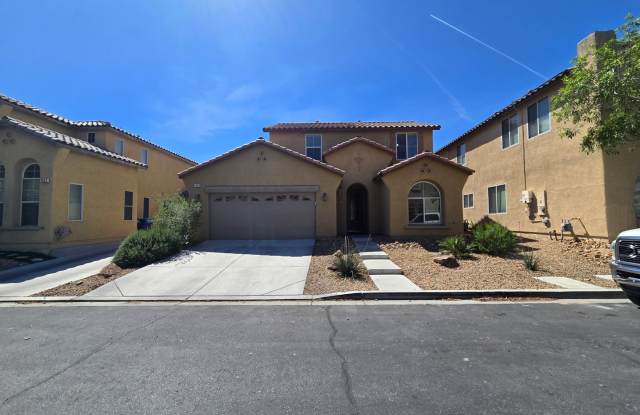 Step outside to a spacious, larger-than-average Las Vegas backyard complete with lush artificial turf, a covered patio, and a pergola photos photos