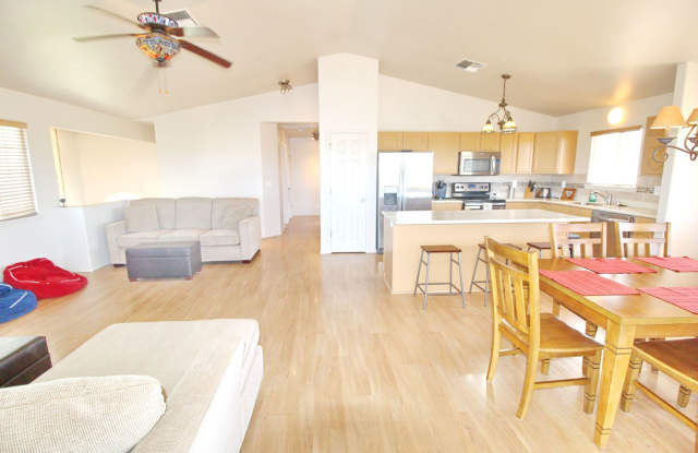 Malimali Street home with garage, fenced yard, central A/C, stainless steel kitchen appliances & sink, large upper lanai, nice flooring, ceiling fans with lights, large kitchen with island, partially furnished Gallery 3