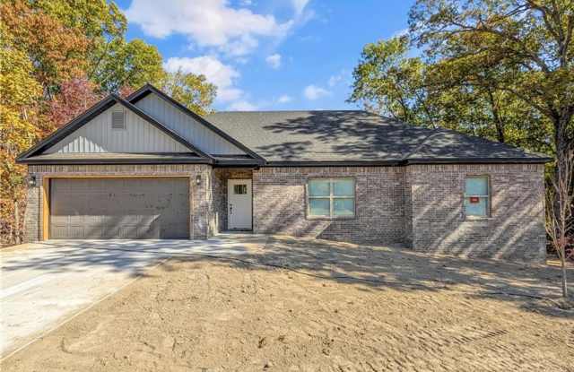 Modern open-concept living meets peaceful nature views in this custom-crafted retreat. photos photos