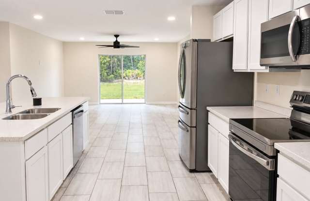 Beautiful four bedroom, two bath, two car garage and a half acre lot Gallery 4
