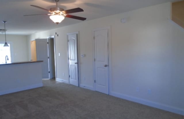 Featuring 2 bedrooms and 2.5 bathrooms. The main level features a welcoming living area, a kitchen with ample cabinet space, and a convenient half bathroom. Gallery 4