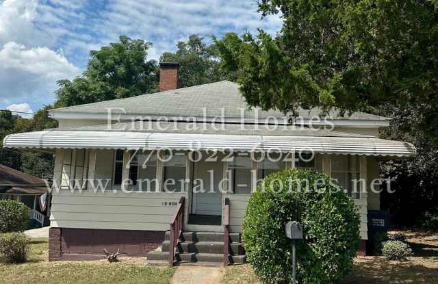 Rent NOW! Charming and spacious historic home in Porterdale Village featuring three bedrooms, two full bathrooms, and a versatile bonus room. - 1 Birch Street, Porterdale, GA 30014