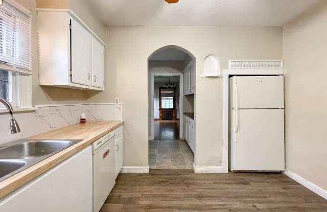 Large, 5 bedroom Home with wood flooring and updated bathroom, close to campus with a fenced yard and fire pit. Gallery 3