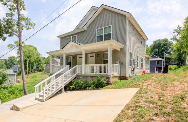 Two Story Duplex With Hardwood Flooring and White Cabinetry photos photos