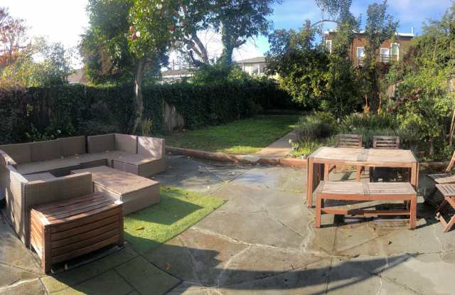 Sunny one bedroom house surrounded by lush backyard and gardens. photos photos