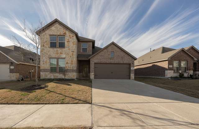 North-facing home featuring a large covered L-shaped patio and garage with Polyspartic scratch-resistant paint, a versatile under-stair closet, a modern kitchen, and elegantly designed bathrooms. photos photos