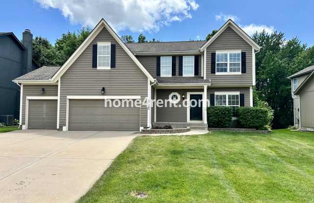 Beautiful Four-Bedroom Home with Three Car Garage, Wood Floors, Finished Basement and a Fenced Yard!! photos photos