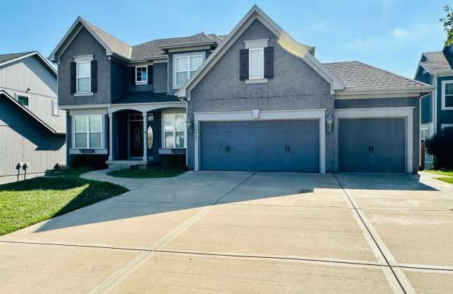 {20067} Custom Built Home in Woodland Manor + Open Main Level with Modern Lighting and Hardwood Flooring + Finished Walk Out Basement + Enclosed Sunroom + Three Car Garage + Fenced Yard photos photos