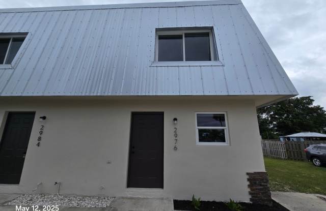 This renovated home provides modern convenience with a durable metal roof, impact-resistant windows, and brand-new carpeting throughout. photos photos