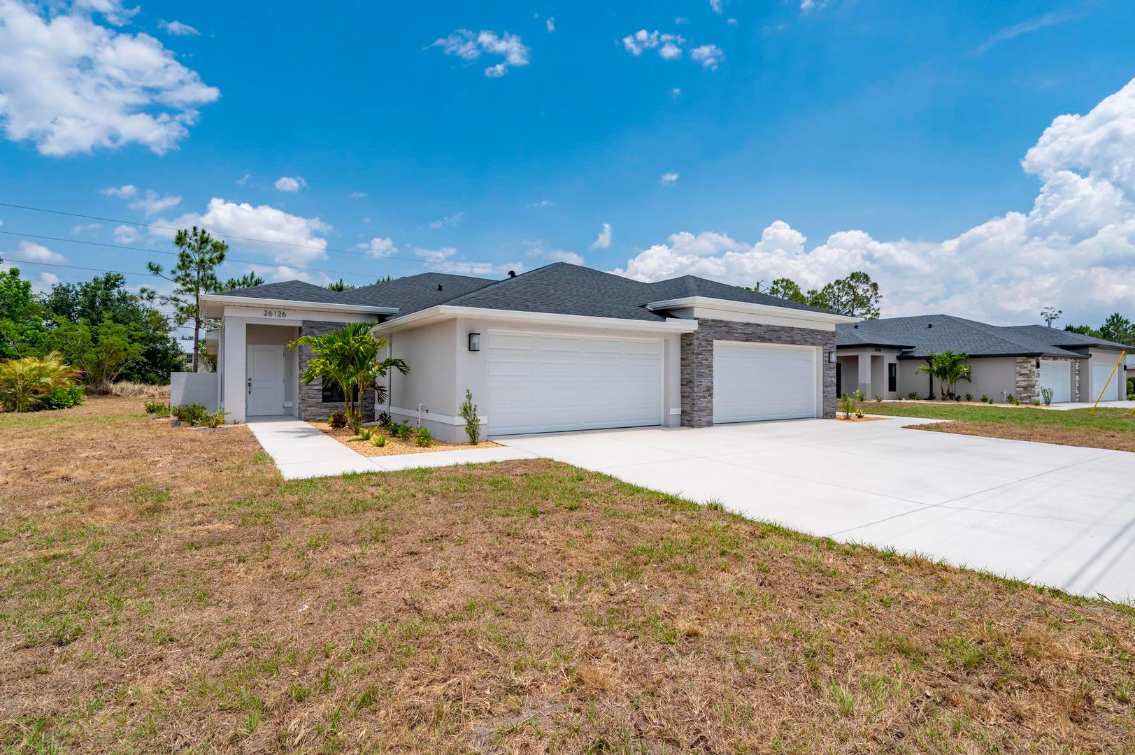 NEW Villa-duplex home with quartz counters, 2-car garage, and a rear patio – photo 1