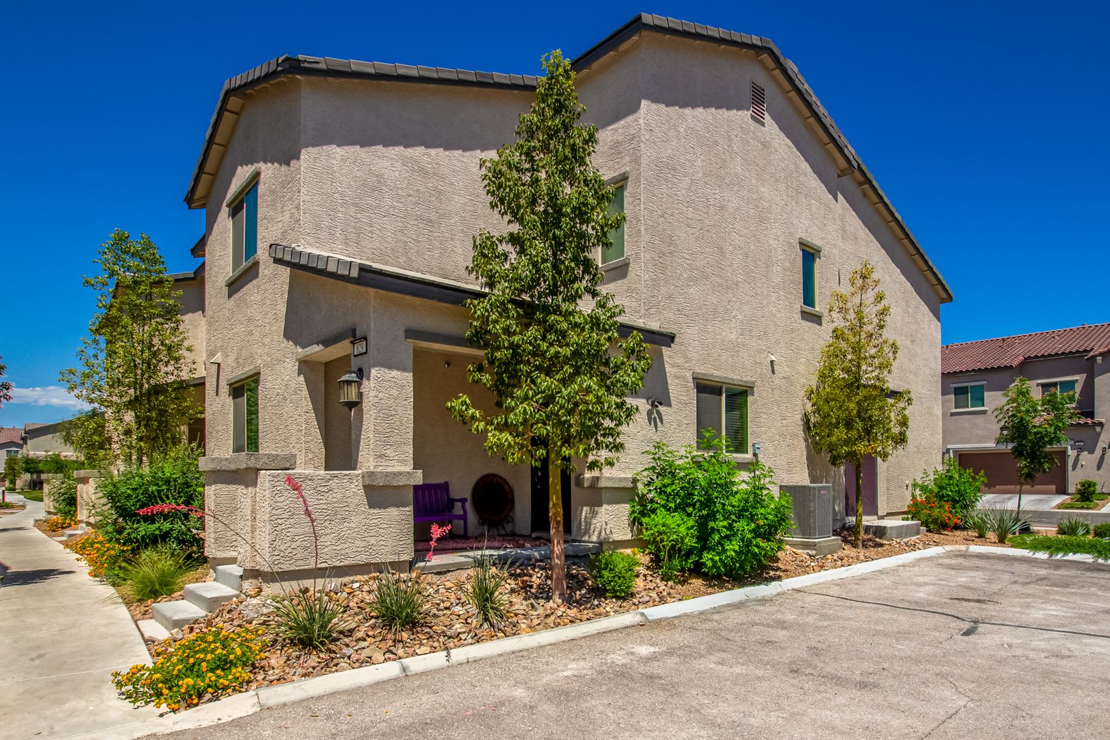Beautiful corner lot townhome with custom paint, plentiful community green spaces. – photo 1