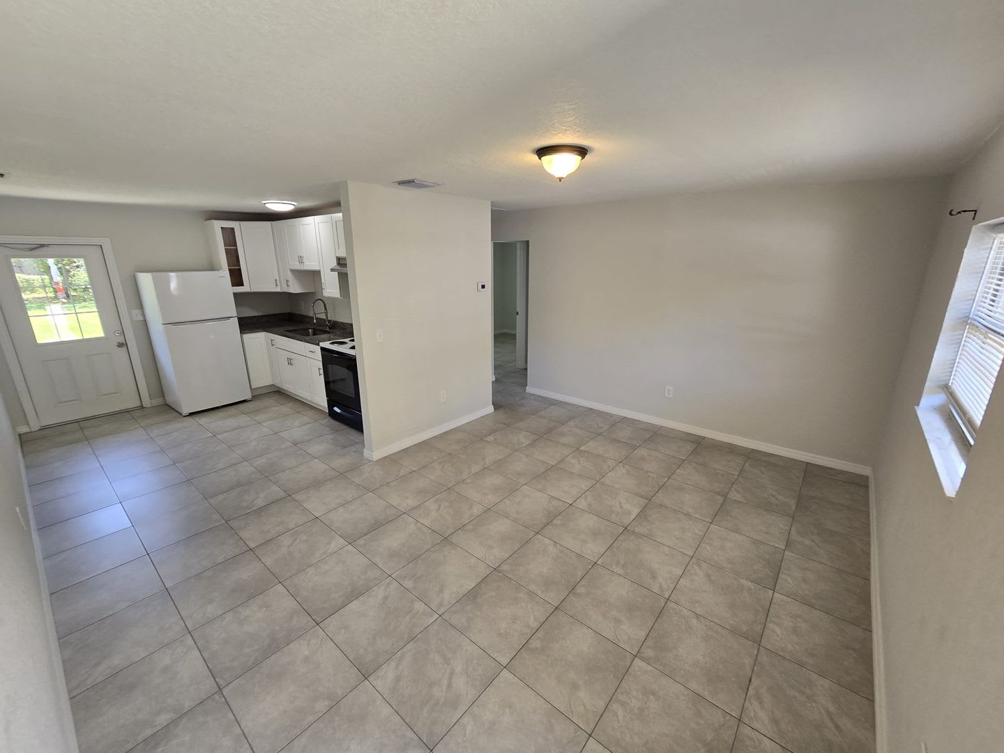 Beautiful Open Floor Plan 2 Bedroom 1 Bathroom Home 2 Car Parking Open Kitchen With Wood Cabinets And Newly Installed Tile Flooring Throughout The Home – photo 2