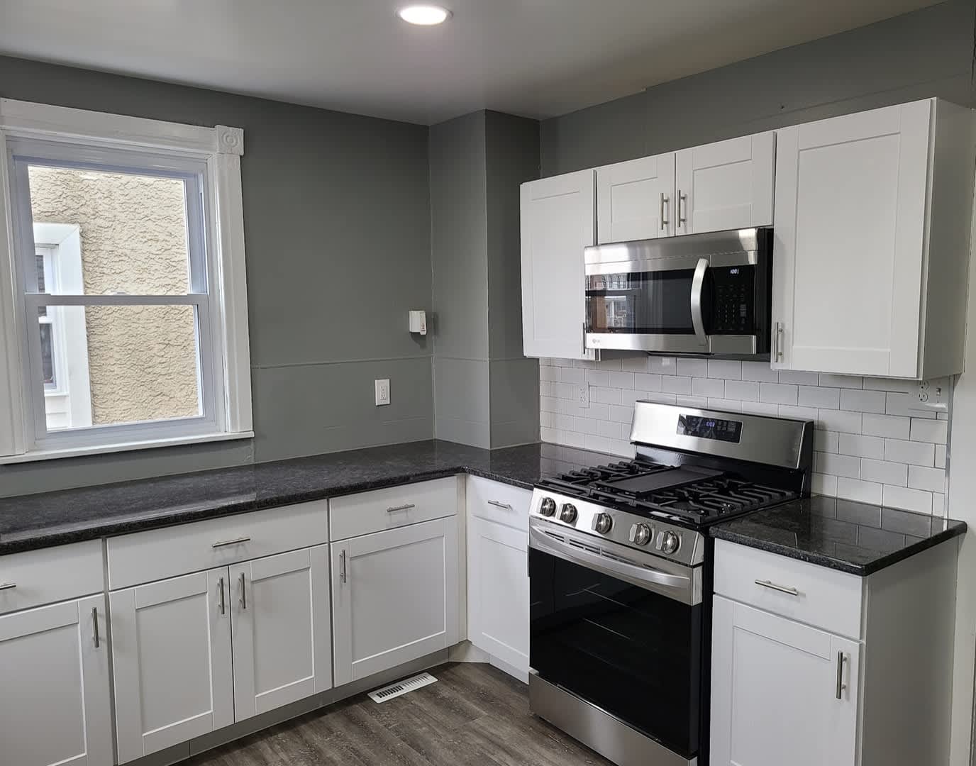 Twin home with updated kitchen, washer/dry on first floor, private back yard and porch. – photo 3